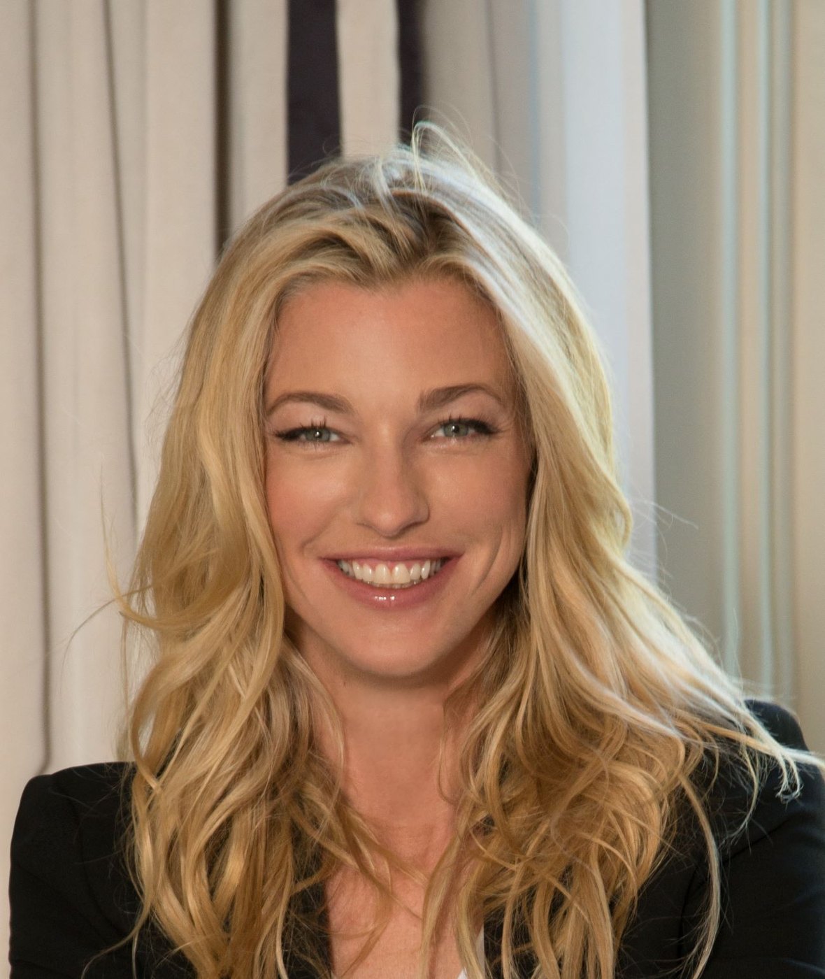 Nicole Junkerman smiling warmly in soft, pale light
