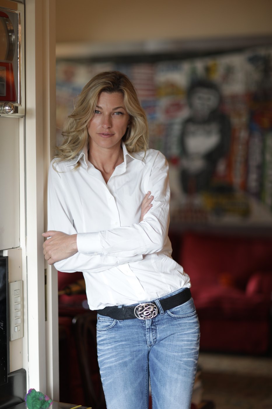 Nicole Junkerman standing in a doorway in a bright home interior, a relaxed portrait